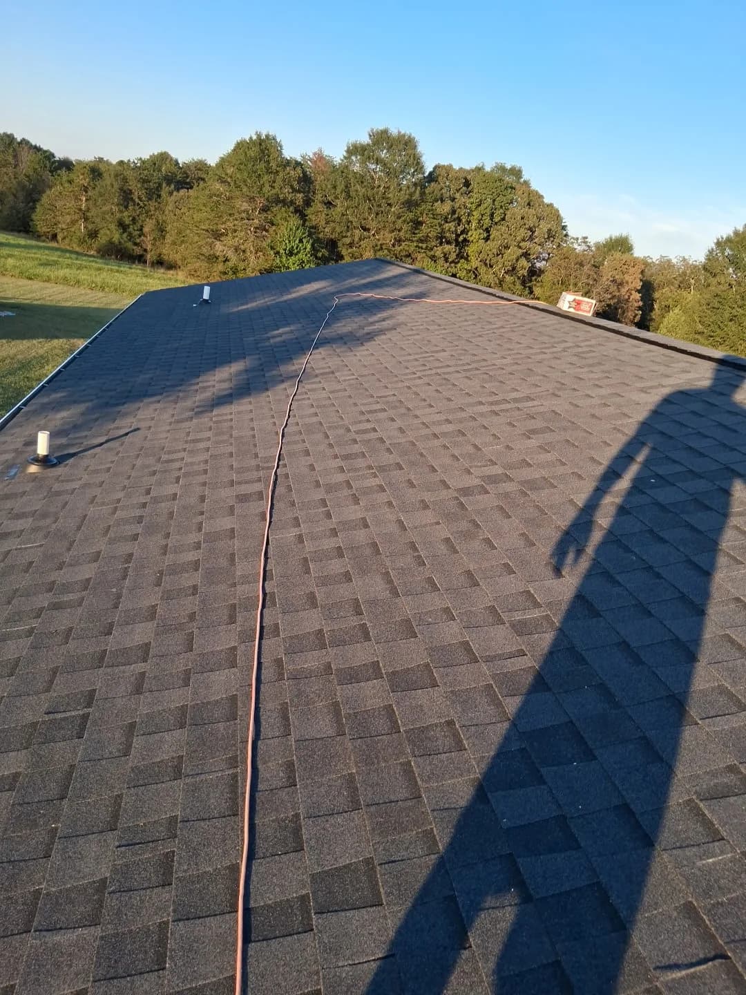 Completed roof with Sage Roofing Solutions crew truck nearby