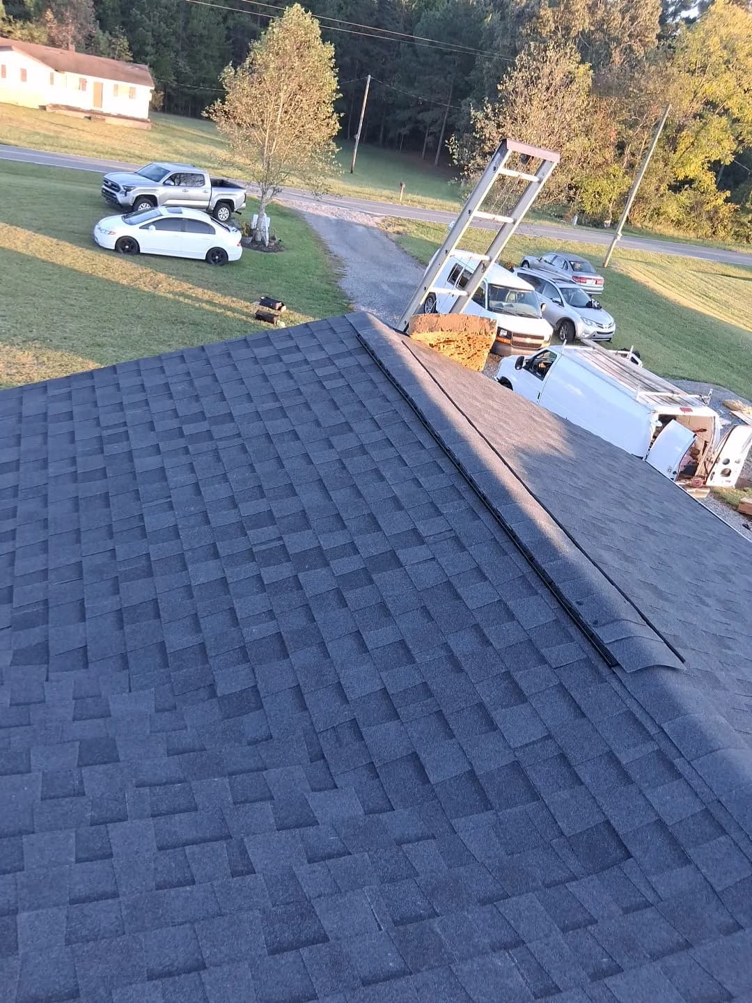 Wide view of a newly installed dark shingle roof in North Carolina